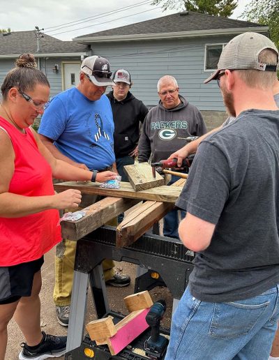 Volunteers gathered around a work bench